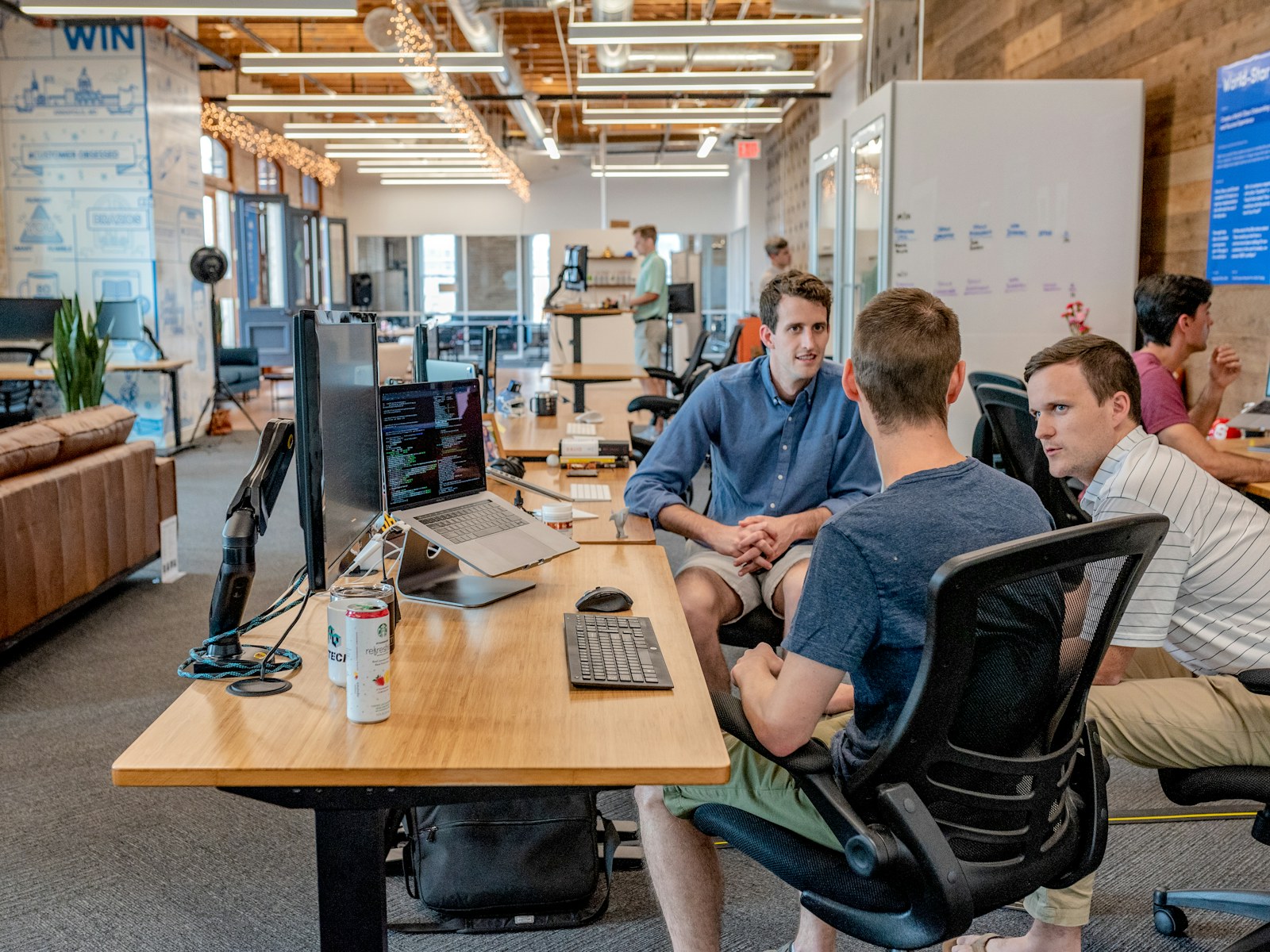 team collaborating around a table on a product workflow